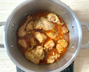 Cooked chicken pieces in pot