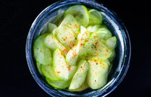 Cucumber slices with juice in a bowl