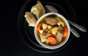 beef goulash soup with bread in a bowl